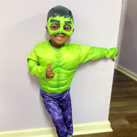 Small child in a Hulk costume.