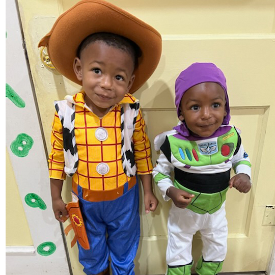 Two small children in a Woody and Buzz costume.